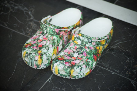 Mulhouse - France - 13 June 2021 - Closeup of plastic printed flowers shoes by crocs in a fashion store showroomのeditorial素材