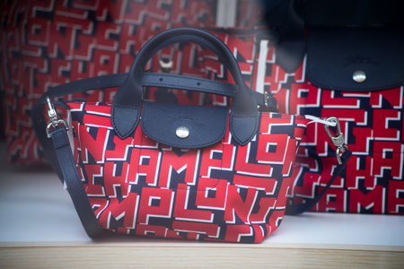 Mulhouse - France - 28 June 2021 - Closeup of red and blue handbags by Longchamp in a luxury fashion...