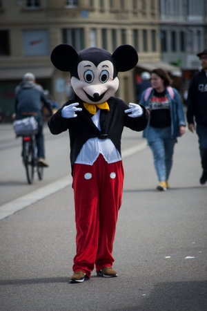 Basel - Switzerland - 6 August 2021 - portrait of man with mickey mouse costumestanding in the streetのeditorial素材