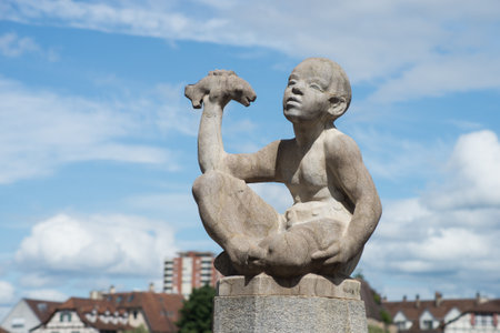 Basel - Switzerland - 6 August 2021 - view of stoned statue in border the rhine riverのeditorial素材
