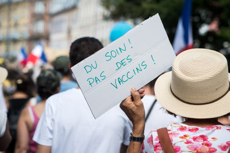 Mulhouse - France - 14 August 2021 - People protesting in the street with banner in french, du soin pas des vaccins, in english : care not vaccinesのeditorial素材