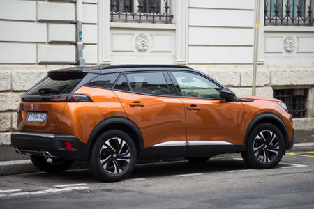 Mulhouse - France - 22 August 2021 - Rear view of orange Peugeot 2008 parked in the street