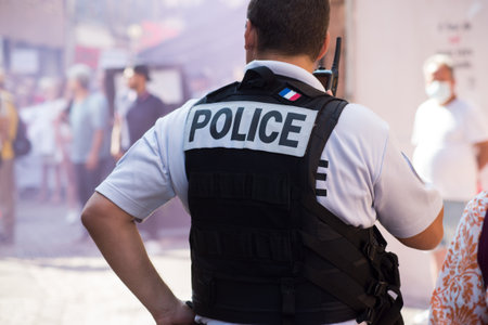Colmar - France - 4 September 2021 - Portrait on back view of french police man standing in the...