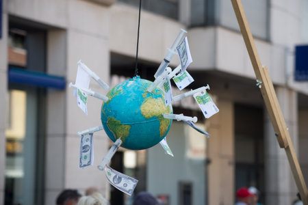 Colmar - France - 4 September 2021 - closeup of vaccination syringe in earth with bank notes for...