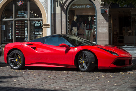 Colmar - France - 4 September 2021 - Profile view of red ferrari parked in the street