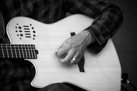 Closeup of hands of musician playing guitar in the streetの写真素材