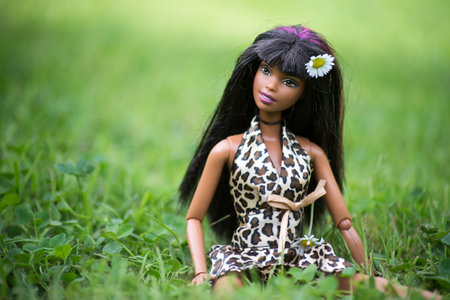 Mulhouse - France - 28 September 2021 - Portrait of black barbie doll wearing a printed leopard dress sitting in a public gardenのeditorial素材