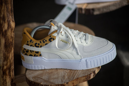 Mulhouse - France - 8 August 2021 - Closeup of white and printed leopard sneakers by puma in a fashion store showroomのeditorial素材