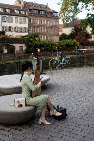 Strasbourg - France - 23 October 2021 - Portrait of asian woman playing traditional chinese violin in the streetのeditorial素材