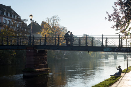 Strasbourg - France - 6 November 2021 - view of metallic bridge and people silhouettes on il riverのeditorial素材