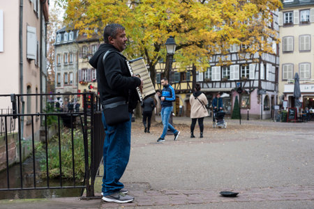 Colmar - France - 13 November 2021 - Portrait of musician playing accordion in the streetのeditorial素材