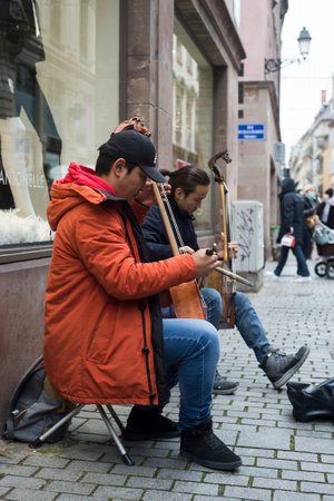 Strasbourg - France - 29 November 2021 - Portrait of musician playing traditional Mongolian violin in the streetのeditorial素材