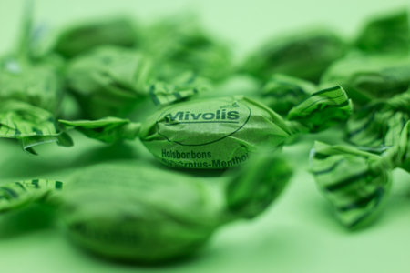 Mulhouse - France - 2 December 2021 - Closeup of mint and eucalyptus candies on green backgroundのeditorial素材