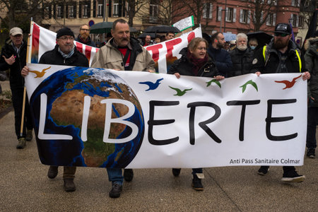 Colmar - France - 4 December 2021 - people protesting against the sanitary pass  with banner in french : liberte, freedom in englishのeditorial素材