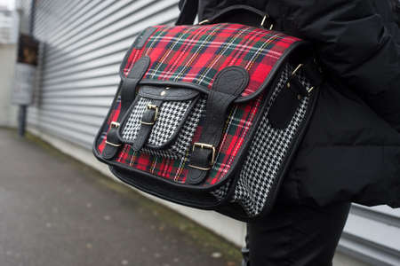 Closeup of printed scottish pattern hand bag on woman standing in the streetの写真素材