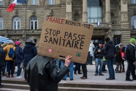 Strasbourg - France - 18 December 2021 -  People protesting with banner in french, stop pass sanitaire, in english : Stop sanitary passのeditorial素材