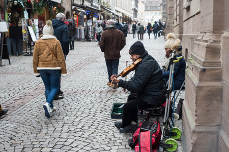 Strasbourg - France - 18 December 2021 - Portrait of violinist  playing in the streetのeditorial素材