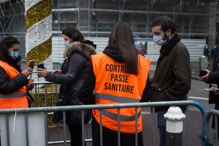 Strasbourg - France - 25 December 2021 - Portrait on back view of man controlling the sanitaire pass...