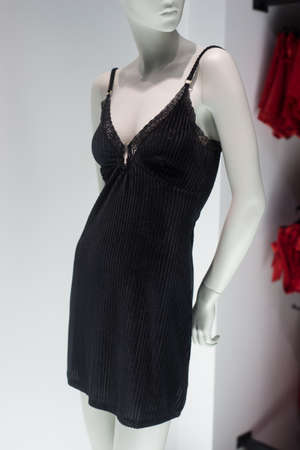 Closeup of black dress on mannequin in a fashion store showroomの写真素材