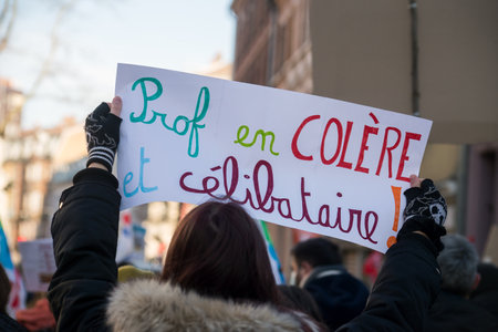 Mulhouse - France - 13 January 2022 - Portrait of french teacher protesting with placard in french : prof en colere et celibataire, in english : angry teacher and singleのeditorial素材