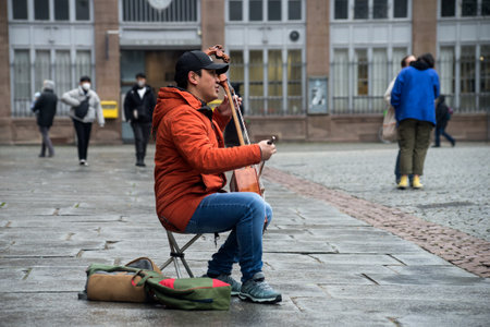 Strasbourg - France - 15 January 2022 -  Portrait of musician playing traditional Mongolian violin...