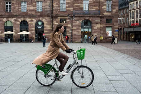 Strasbourg - France - 1 February 2022 - Portrait of girl on velhop rental bicycle in the streetのeditorial素材