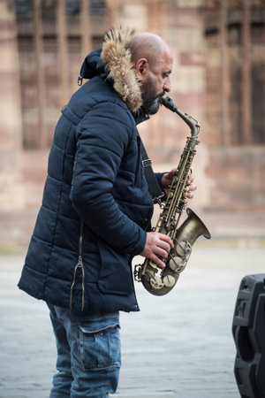 Strasbourg - France - 12 February 2022 - Portrait of musician playing saxophone in the streetのeditorial素材