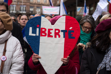 Strasbourg - France - 12 February 2022 - women protesting with a tricolor heart in french : liberte, traduction in english : freedomのeditorial素材