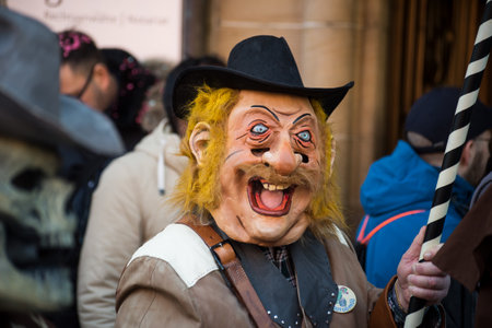 Basel - Switzerland - 9 March 2022 - portrait of masked people wearing traditional costume parading...