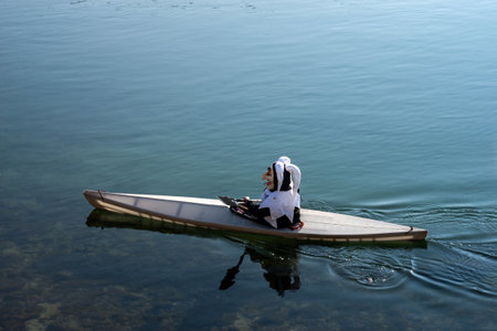 Basel - Switzerland - 9 March 2022 -  Portrait of masked man floating in a canoe on the rhine riverのeditorial素材