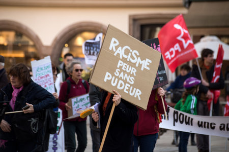 Strasbourg - France - 19 March 2022 - Portrait f people protesting against the racism with placard...