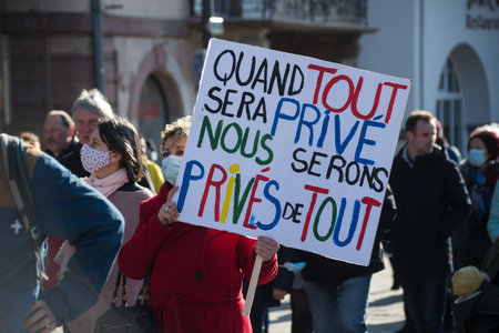 Strasbourg - France - 19 March 2022 - people protesting with placard in french :  nous serons prives de tout, in english : when everything is private, we will be deprived  everythingのeditorial素材
