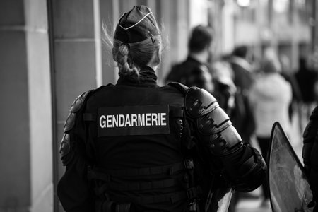 Strasbourg - France - 19 March 2022 - Portrait on back view of french gendarmerie riot policewoman walking in the streetのeditorial素材