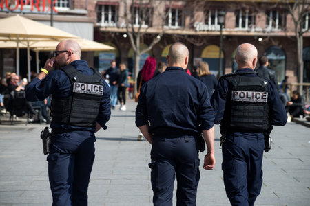 Strasbourg  - France - 26 March 2022 - portrait on back view of policemen patrolling in the streetのeditorial素材