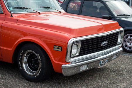 Lutterbach - France - 3 April 2022 - Front view of orange chevrolet pick up  parked in the street