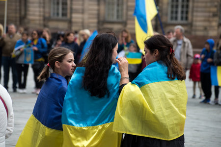 Strasbourg - France - 24 April 2022 - Portrait on back view of woman with ukrainian flag against the warのeditorial素材