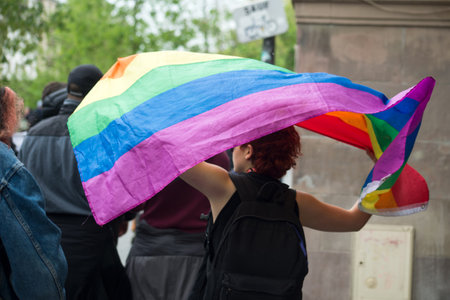 Strasbourg - France - 24 April 2022 - portrait on back view of lesbian girl with rainbow flag protesting in the streetのeditorial素材