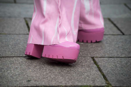 Closeup of pink shoes on woman standing in the streetの写真素材