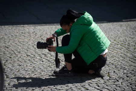 Strasbourg - France - 7 May 2022 - Portrait of woman photographing with camera in the streetのeditorial素材