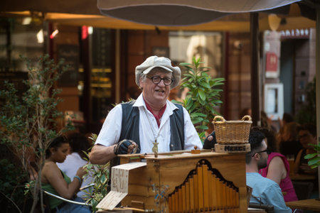 Strasbourg - France - 5 June 2022 -Portrait of man playing with a barrel organ in the streetのeditorial素材