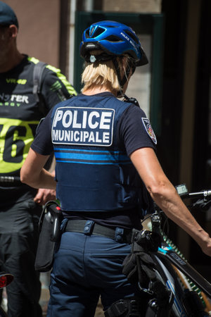 Strasbourg - France - 12 June 2022 - Portrait on back view of french police woman standing in the streetのeditorial素材
