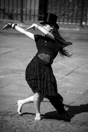 Strasbourg - France - 11 June 2022 - Portrait of barefoot gothic girl dancing in the street
