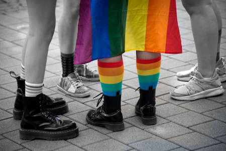 Closeup of rainbow socks and rainbowflag on lesbian women during the gay pride