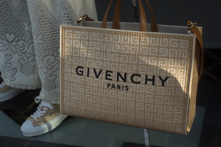 Mulhouse - France - 18 june 2022 - Closeup of beige summer bag by Givenchy  in a luxury fashion store showroomのeditorial素材