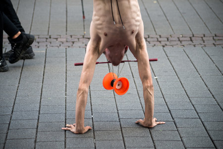 Strasbourg - France - 25 June 2022 - portrait of young man playing with diabolo in the street