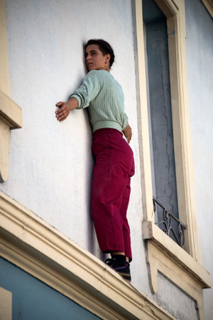 Mulhouse - France - 17 July 2022 - Portrait of street artist climbing at the building facade during the street scene festivalのeditorial素材