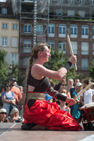 Strasbourg - France - 9 July 2022 - people wearing traditional costume playing japanese drums in the streetのeditorial素材