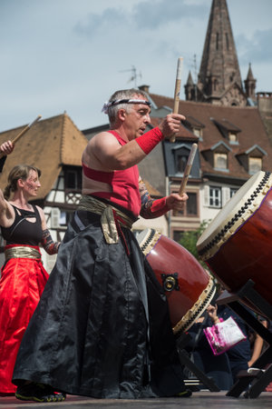 Strasbourg - France - 9 July 2022 - people wearing traditional costume playing japanese drums in the streetのeditorial素材