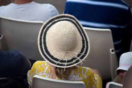 Portrait on back view of tourist wearing a summer hat in a cruise boat