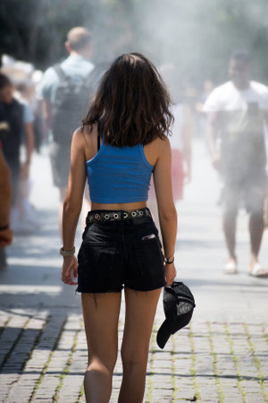 Strasbourg - France - 6 August 2022 - Portrait of young woman walking in sprayer installation at the main placeのeditorial素材